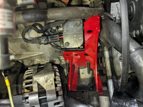Alternator about to be installed in its custom bracket, in the SPICA pump's old spot